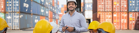 a foreman in a workplace talking to colleagues in hard hats
