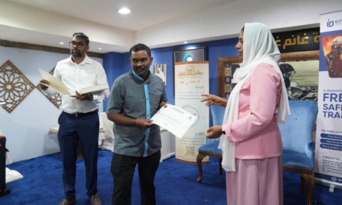 Certificate being presented to learner at REWAQ