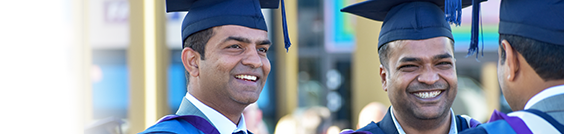 Two men in Graduation caps and gowns